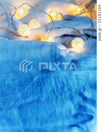 Background of garlands with lights on the folds of 53162164