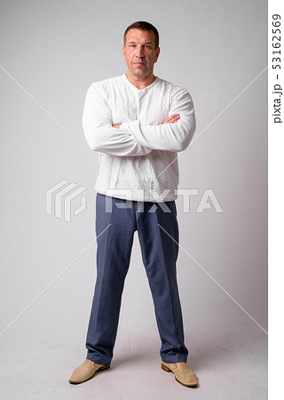 Full body shot of macho mature man with arms crossed 53162569