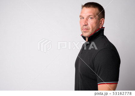 Profile view of macho mature man looking at camera Profile view of macho mature man looking at camera 53162778