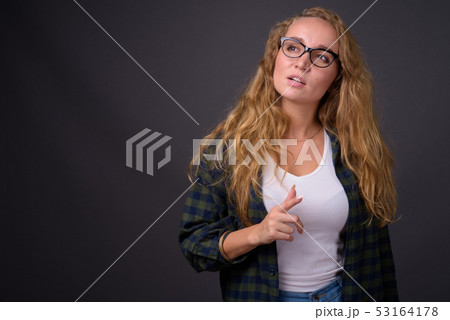 Portrait of young beautiful woman with long wavy blond hair 53164178