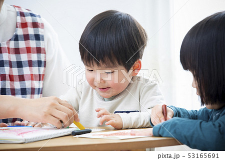 保育士と子供たち お絵かきの写真素材