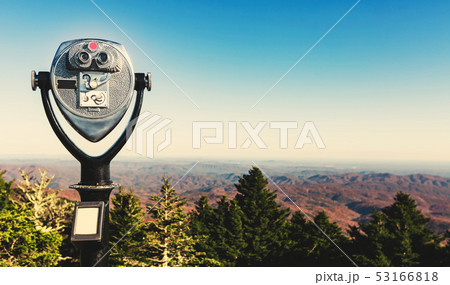 Coin-operated binoculars looking out over a mountain landscape Coin-operated binoculars looking out over a mountain landscape 53166818