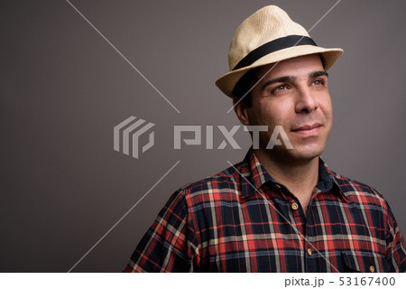 Handsome Persian tourist man ready for vacation against gray bac Handsome Persian tourist man ready for vacation against gray bac 53167400