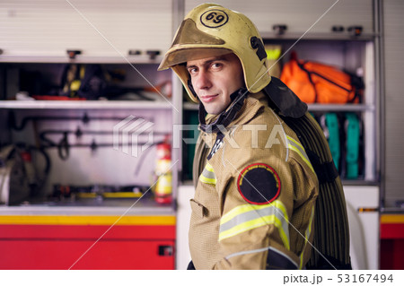 Picture of man fireman in helmet on background of fire truck Picture of man fireman in helmet on background of fire truck 53167494