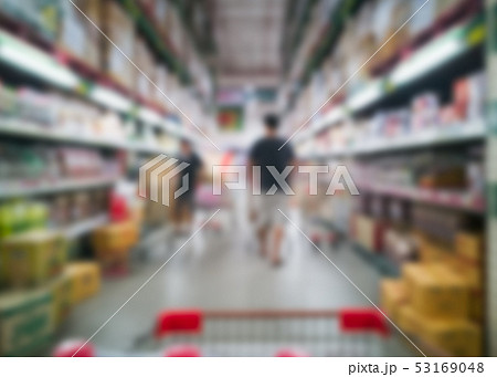 Shopping cart in aisle racks of products stock in Shopping cart in aisle racks of products stock in 53169048