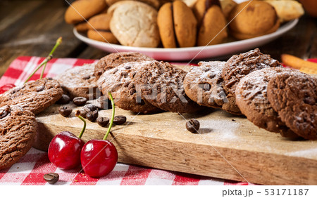 Oatmeal chocolate cookies with coffee grains and cherry. Sun flare 53171187