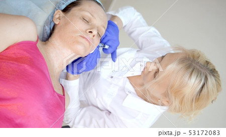 The cosmetologist makes injections, anti-aging procedures for tightening and smoothing wrinkles on 53172083