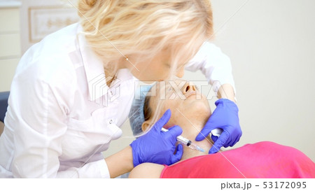 The cosmetologist makes injections, anti-aging procedures for tightening and smoothing wrinkles on 53172095