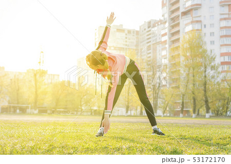 woman stretches bending over to the foot 53172170