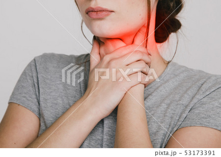Sore throat. Woman holding hands on her throat. Heartburn concept. 53173391