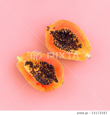 Half cut papaya on color background Half cut papaya on color background 53173587