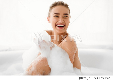 Happy Woman Playing With Foam In Bathtub 53175152
