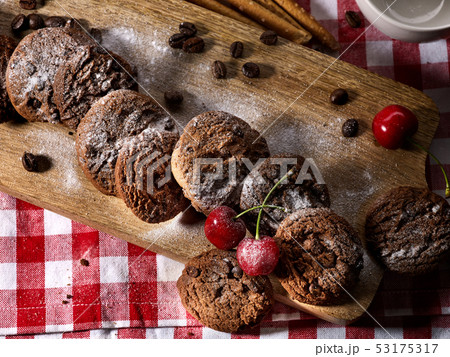 Oatmeal chocolate cookies with coffee grains and cherry. Sun flare 53175317