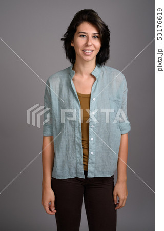 Young beautiful woman against gray background Young beautiful woman against gray background 53176619