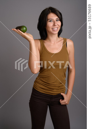 Young beautiful woman against gray background 53176689