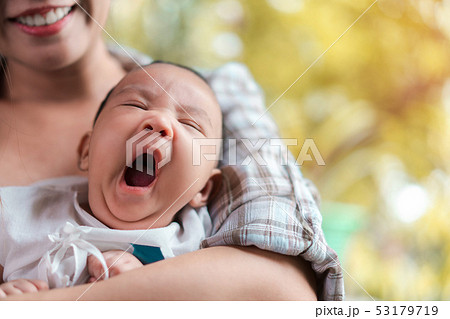 Young asian woman holding a newborn baby in her 53179719