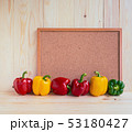 sweet peppers on wooden table. 53180427
