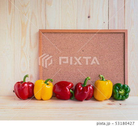sweet peppers on wooden table. 53180427