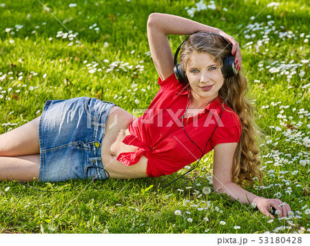 Girl in headphones and denim skirt catch rhythm music 53180428