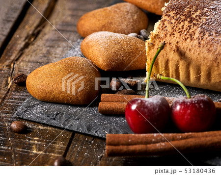 Sand cookies heart shape and rolled cake with cherry and coffee bean 53180436