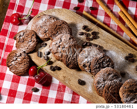 Oatmeal chocolate cookies with coffee grains and cherry. Sun flare Oatmeal chocolate cookies with coffee grains and cherry. Sun flare 53180461