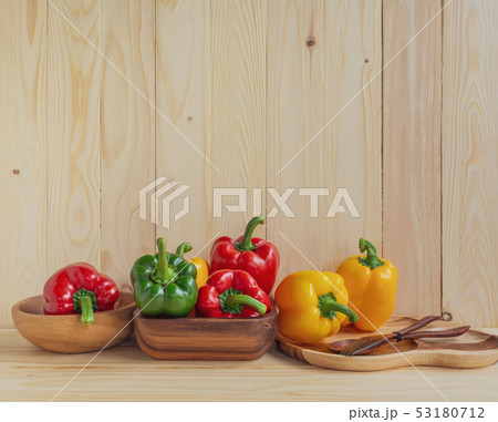 sweet peppers on wooden table background 53180712