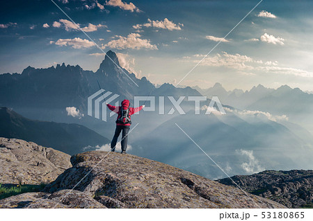 Mountaineer with backpack on rock Mountaineer with backpack on rock 53180865