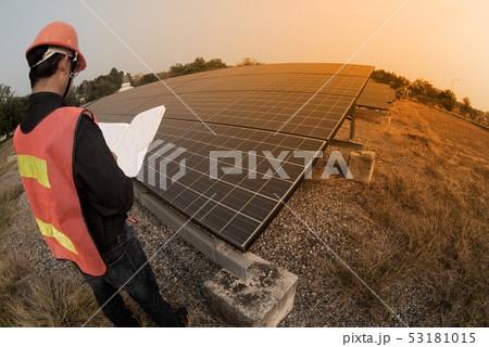 Worker in uniform and helmet checks Solar cell. 53181015