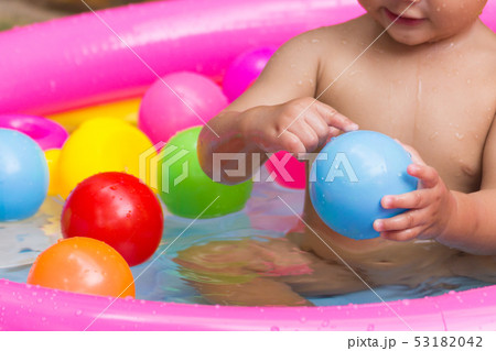 Close up hands baby playing colorful balls. 53182042