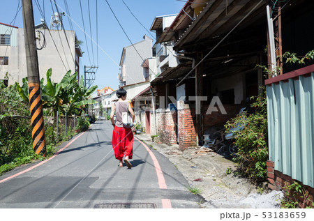 modern mature Asian woman walking on the street modern mature Asian woman walking on the street 53183659