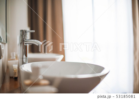 Modern stylish washbasins with chrome taps. Luxury lifestyle. Close-up, selective focus Wood texture 53185081