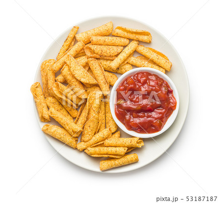 Rolled mexican nacho chips and salsa dip. 53187187
