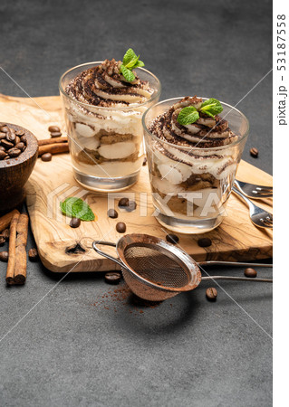 Classic tiramisu dessert in a glass on dark concrete background 53187558