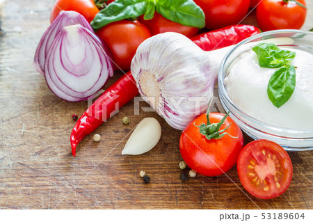 Tomato sauce and ingredients on white wood background 53189604