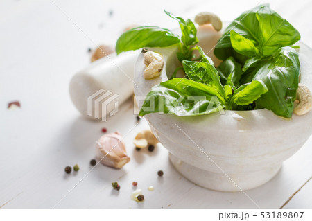 Pesto sause and ingredients on white background Pesto sause and ingredients on white background 53189807