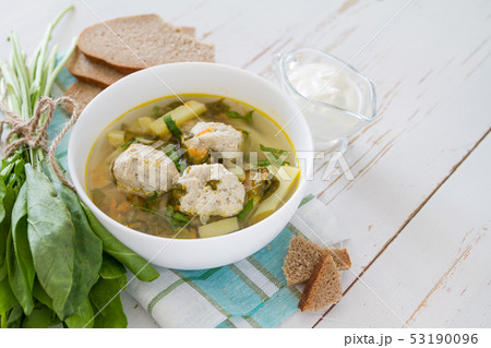 Sorrel soup in white bowl 53190096
