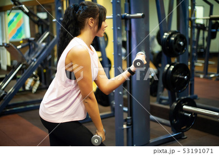 Fitness Girl. Sexy athletic girl working out in gym. Fitness woman doing exercise Fitness Girl. Sexy athletic girl working out in gym. Fitness woman doing exercise 53191071