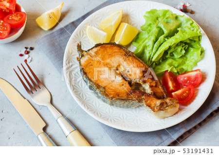 Steak baked salmon fish on a plate with fresh vege Steak baked salmon fish on a plate with fresh vege 53191431
