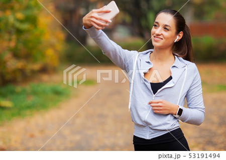 Fitness. Sport woman taking selfie photo on mobile phone in summer park Fitness. Sport woman taking selfie photo on mobile phone in summer park 53191494