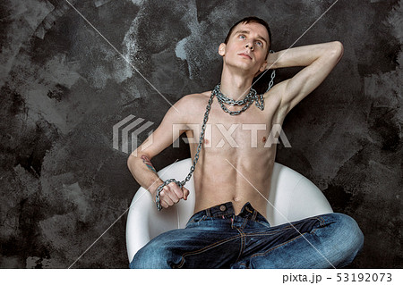 Handsome skinny guy holding a chain. Black Handsome skinny guy holding a chain. Black 53192073