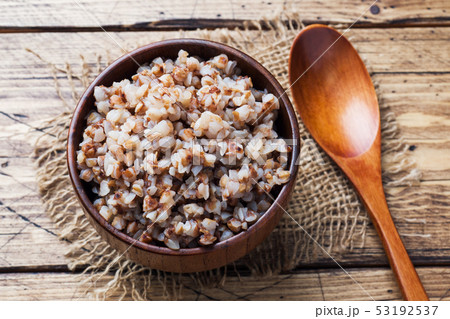 Boiled buckwheat in a wooden bowl on the village Boiled buckwheat in a wooden bowl on the village 53192537
