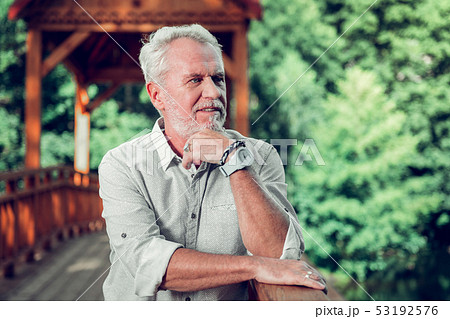 Face close-up portrait of man leaning on the brown bridge. Face close-up portrait of man leaning on the brown bridge. 53192576