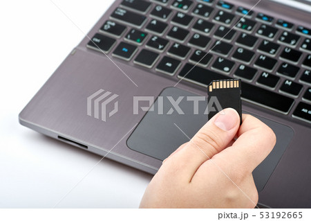 View of a woman holding a black SD card in her View of a woman holding a black SD card in her 53192665