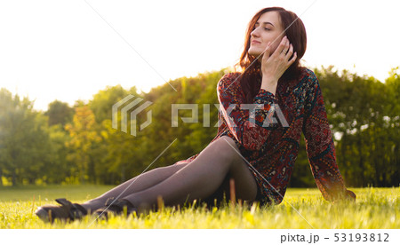 Attractive young woman enjoying her time outside in park 53193812
