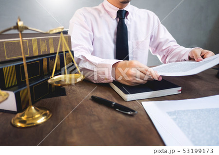 lawyer judge reading documents at desk in 53199173