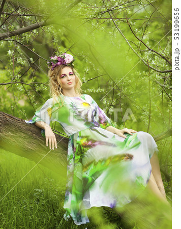 Portrait of a young girl woman in spring forest 53199656