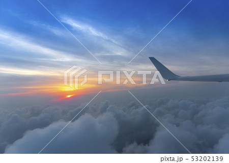 Wing of the air plane on the sea of cloud sunset 53202139
