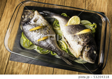 two Dorada fish cooked in the oven with lemon, 53204318