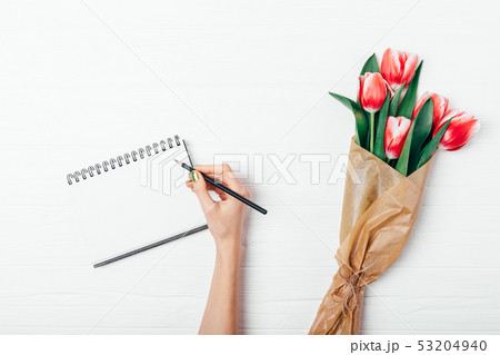 Flat lay composition female's hand with green 53204940