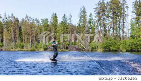 Young pretty slim brunette woman in wetsuit riding 53206265
